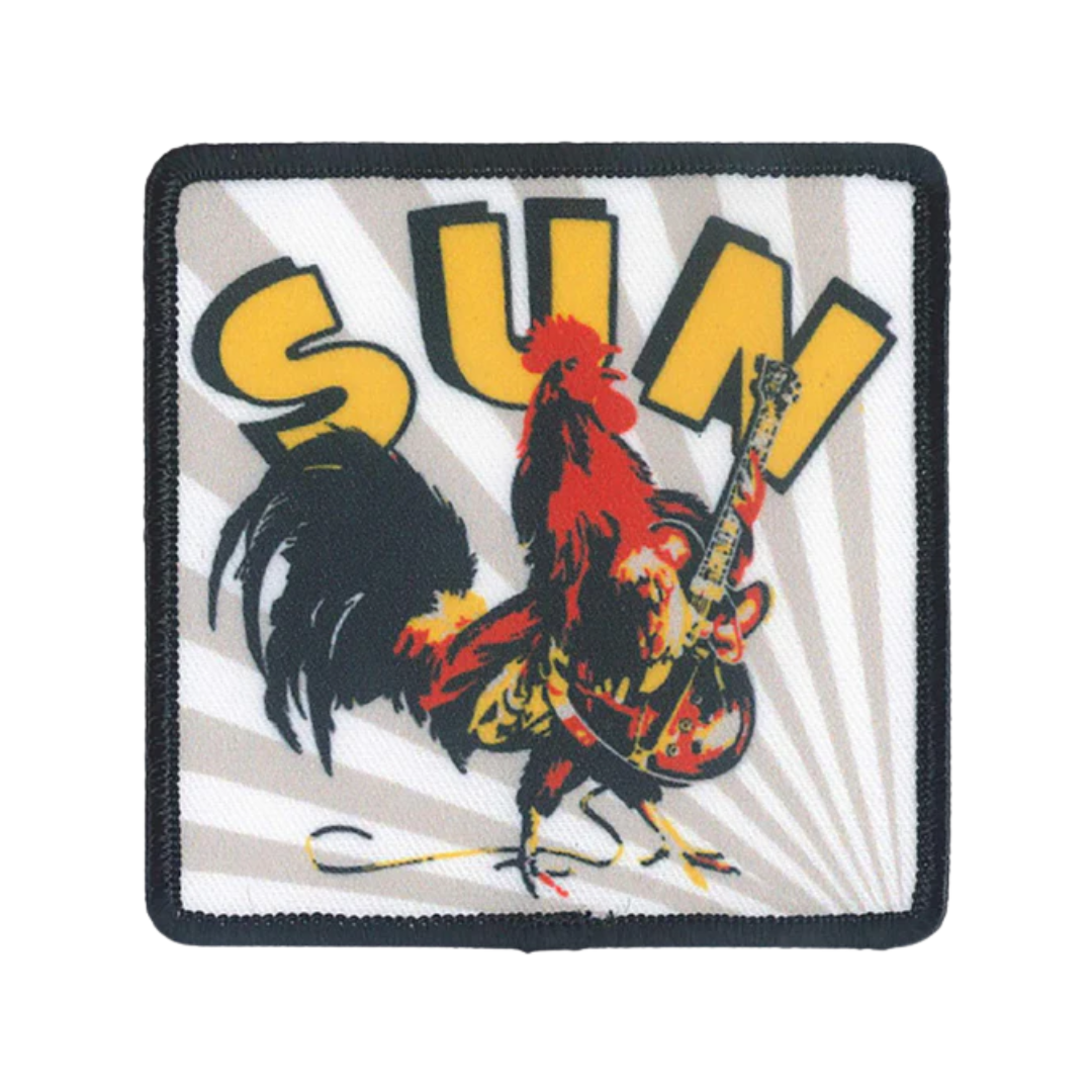 Patch with a rooster playing guitar and the word 'SUN' on a white background