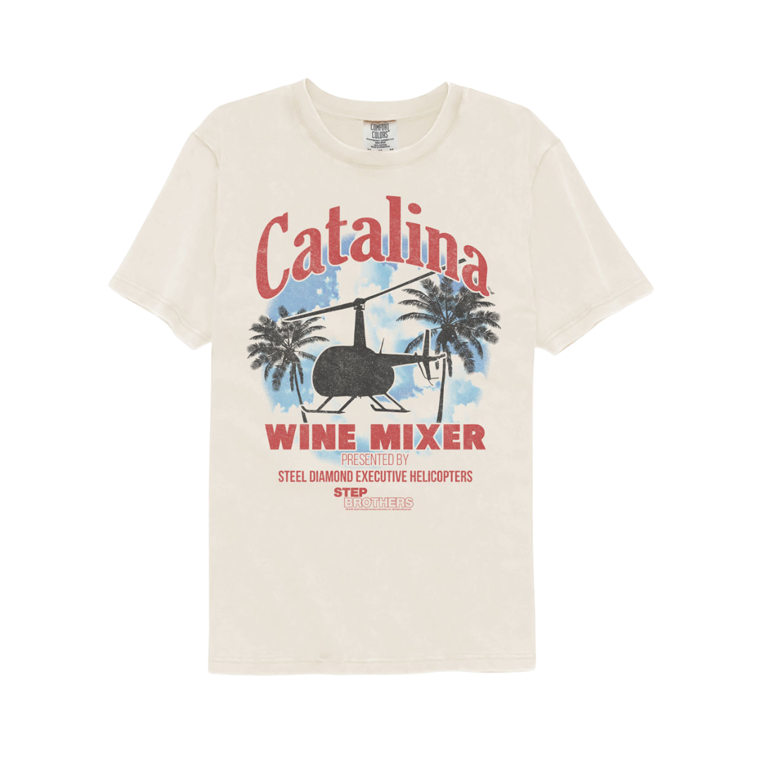 Beige t-shirt with Catalina Wine Mixer graphic design featuring a helicopter and palm trees on a white background.