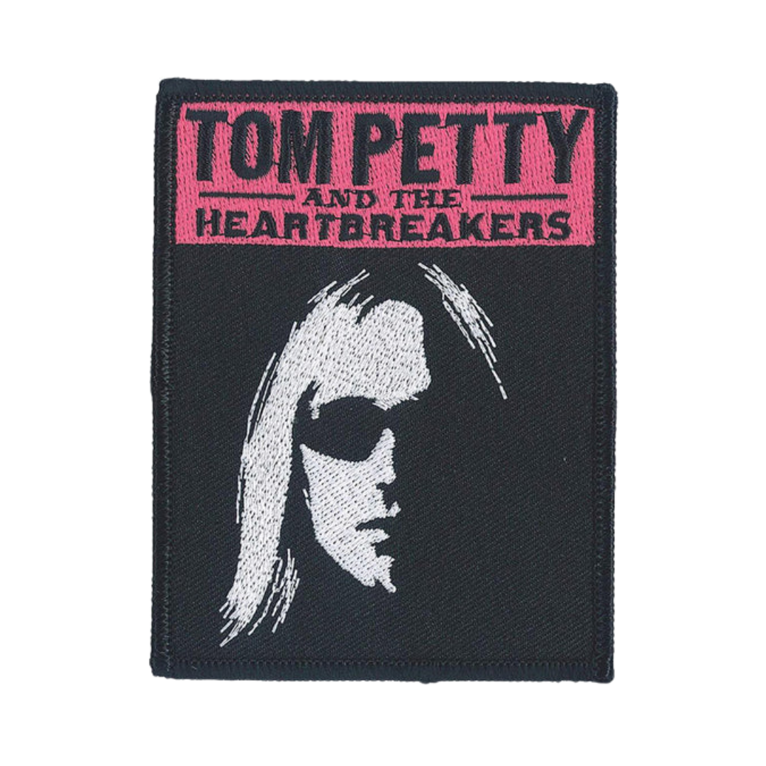 Patch with Tom Petty and the Heartbreakers logo and a silhouette of a person on a black background.