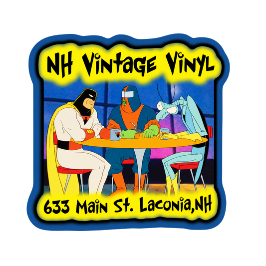 A square vintage-style vinyl sticker or decal with a blue border, yellow background text reading 'NH Vintage Vinyl' and '633 Main St. Laconia, NH,' and a colorful cartoon scene of three masked figures seated around a table.